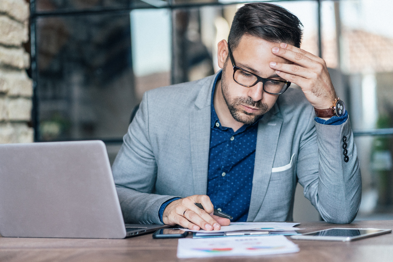 A young businessman experiencing stress during a late night at work